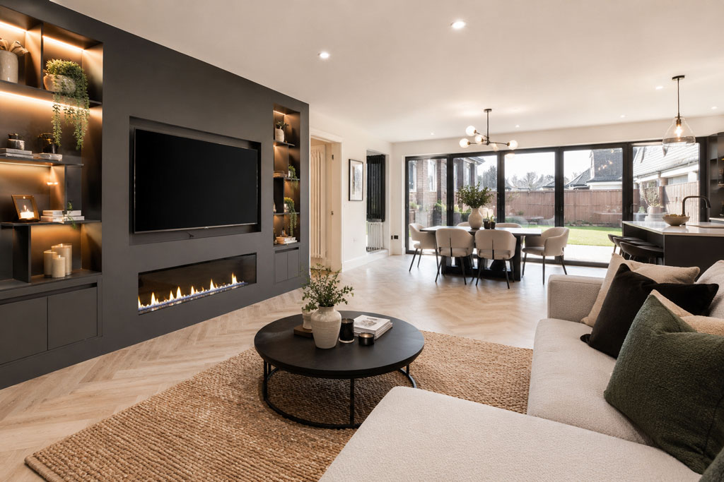 Modern open-plan living room and dining area with dark feature wall, contemporary fireplace, large patio doors, and stylish neutral interior design.